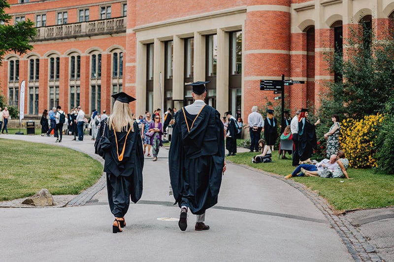 Graduates celebrating on green heart